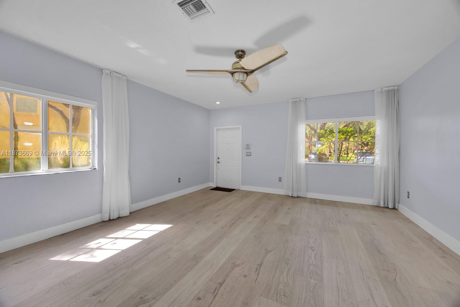 2641 Southwest 83rd Terrace, Unit 104 Miramar, FL 33025 - Photo 6 of 30 wooden floor in an empty room with a window