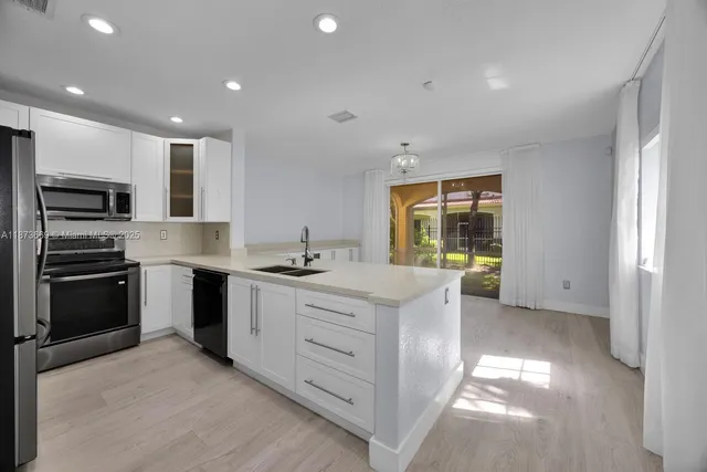 a kitchen with stainless steel appliances granite countertop a stove and a sink