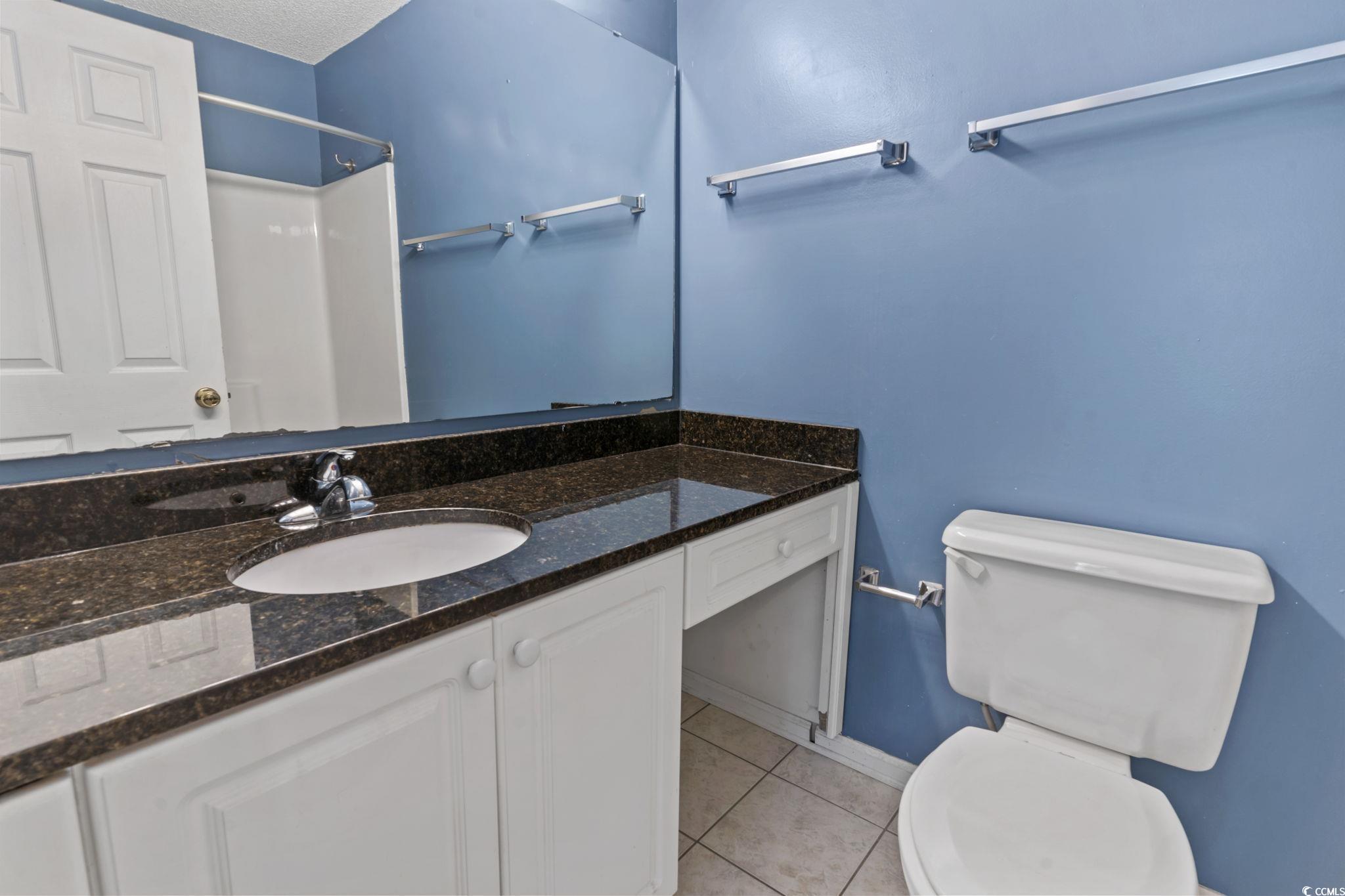 712 67th Avenue North, Unit 2A Myrtle Beach, SC 29572 - Photo 21 of 30 Full bath featuring light tile patterned floors, vanity, and a shower