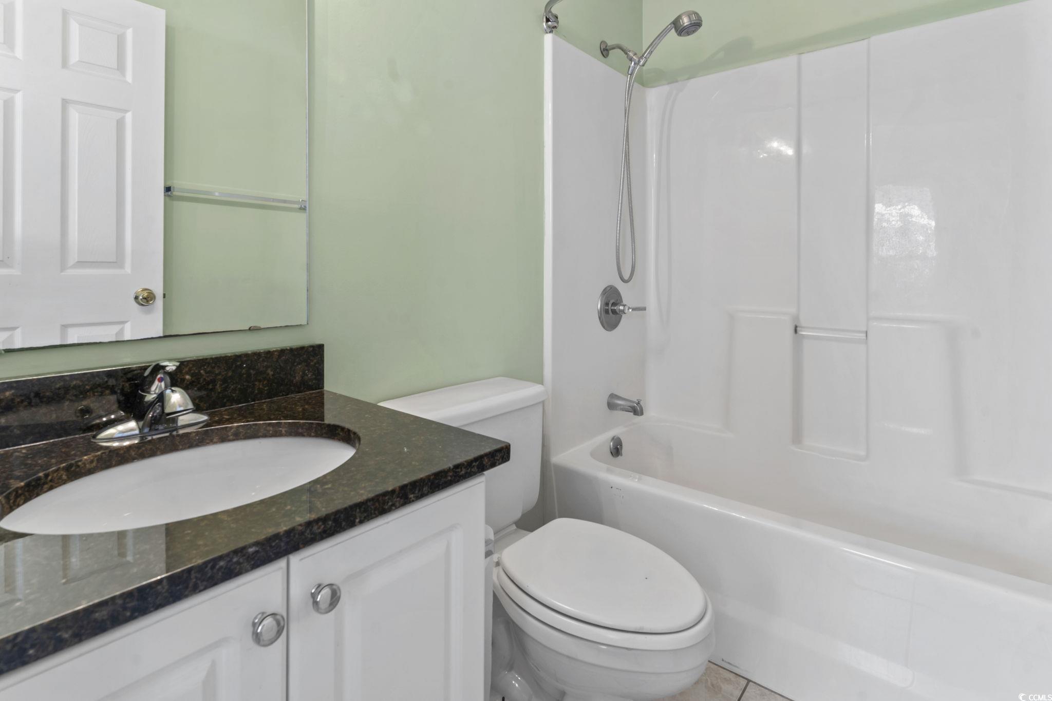 712 67th Avenue North, Unit 2A Myrtle Beach, SC 29572 - Photo 23 of 30 Bathroom featuring vanity, shower / bath combination, and tile patterned flooring