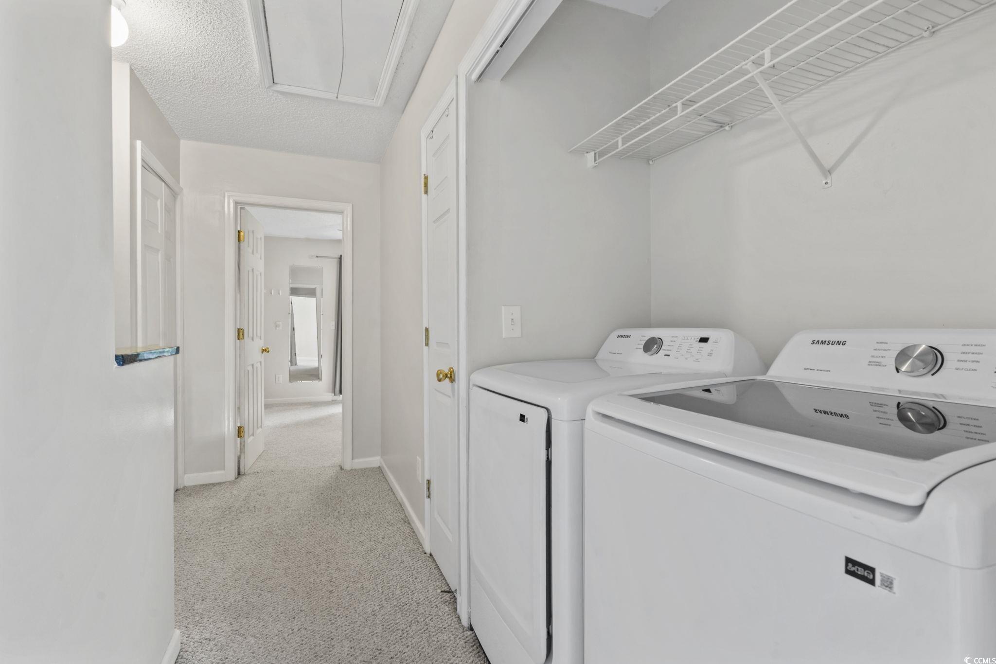 712 67th Avenue North, Unit 2A Myrtle Beach, SC 29572 - Photo 25 of 30 Laundry area featuring light colored carpet, attic access, washing machine and dryer, and a textured ceiling