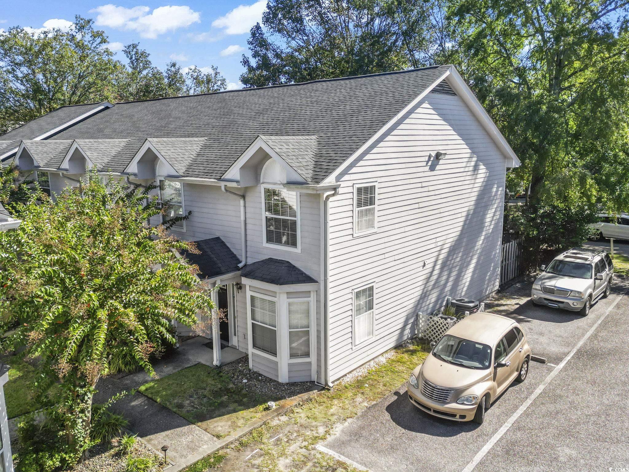 712 67th Avenue North, Unit 2A Myrtle Beach, SC 29572 - Photo 26 of 30 View of side of property with roof with shingles and a sunroom