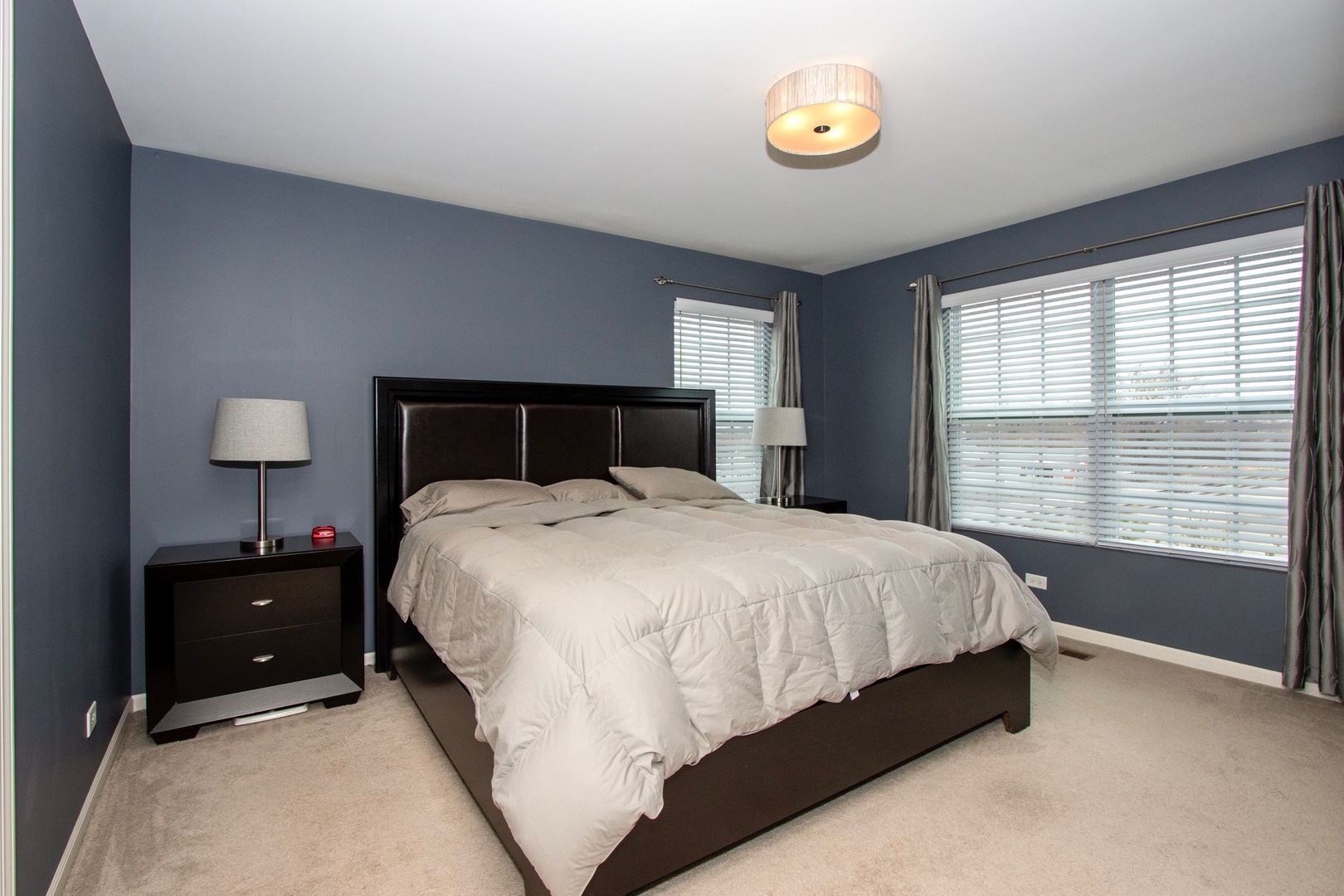 10346 Kerry Ridge Court Chicago Ridge, IL 60415 - Photo 10 of 20 a bed sitting in a bedroom next to a window and a lamp
