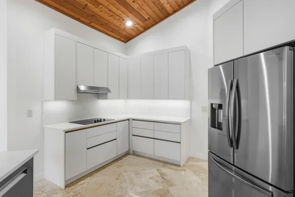a kitchen with stainless steel appliances a refrigerator and a stove