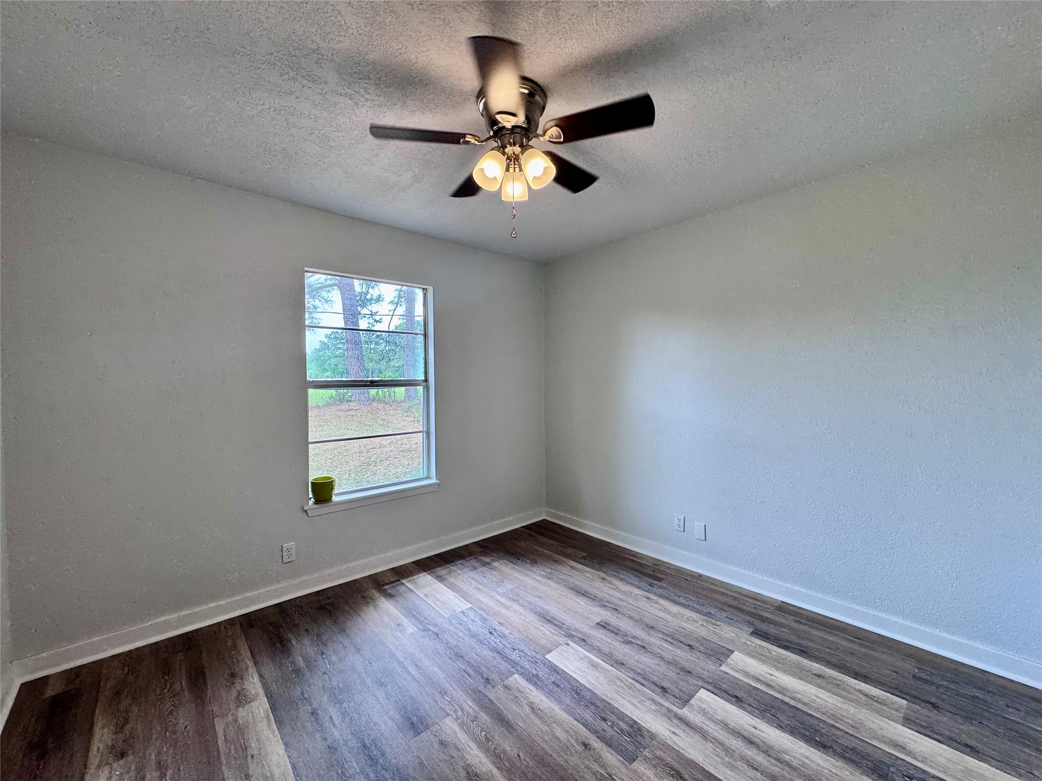 83 Westlake Road Trinity, TX 75862 - Photo 21 of 36 wooden floor in an empty room with a window