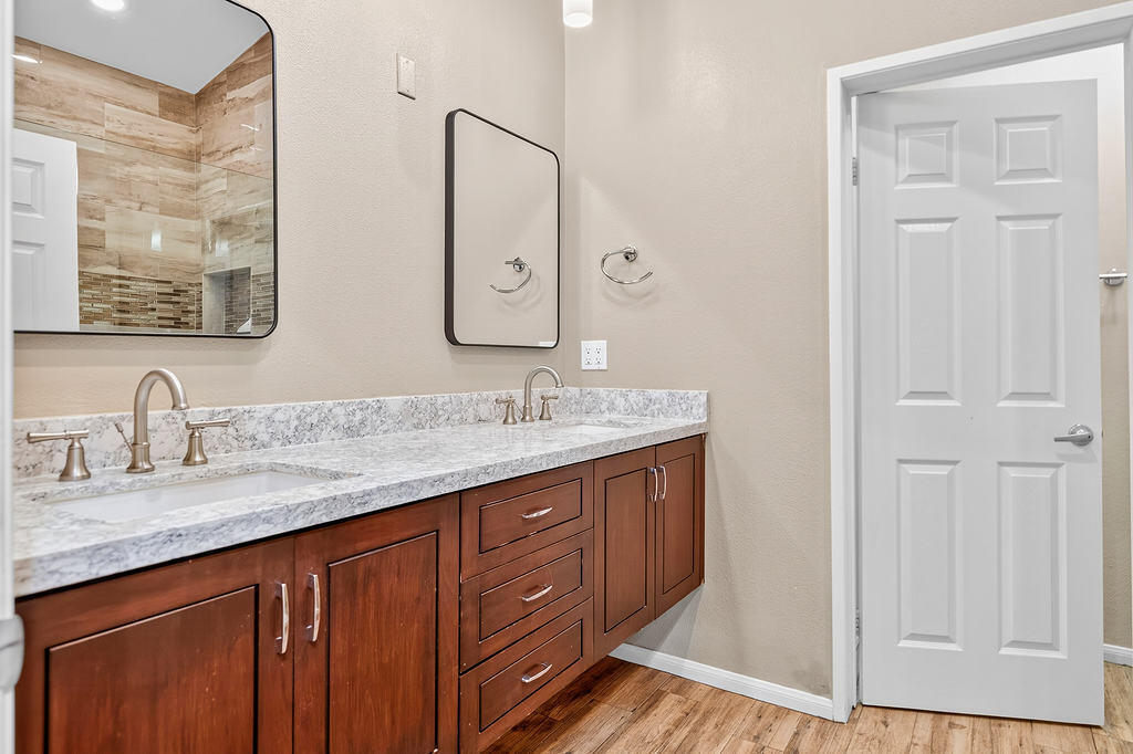 38019 Crocus Lane Palm Desert, CA 92211 - Photo 17 of 28 a bathroom with a granite countertop double vanity sink a mirror and