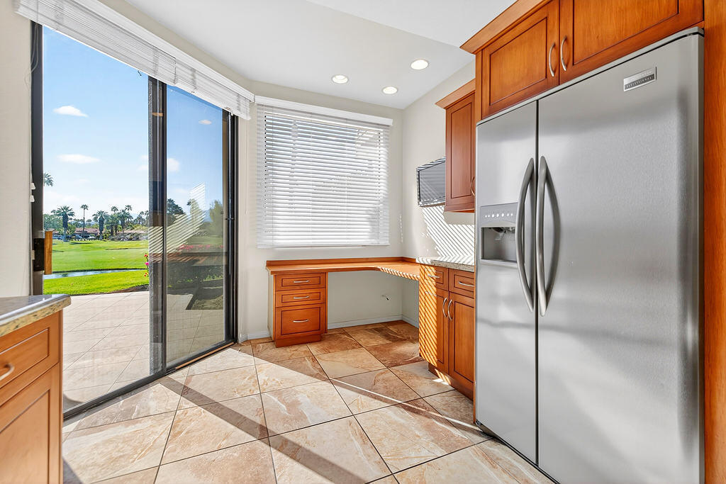 38019 Crocus Lane Palm Desert, CA 92211 - Photo 2 of 28 a kitchen with a refrigerator a sink and a large window
