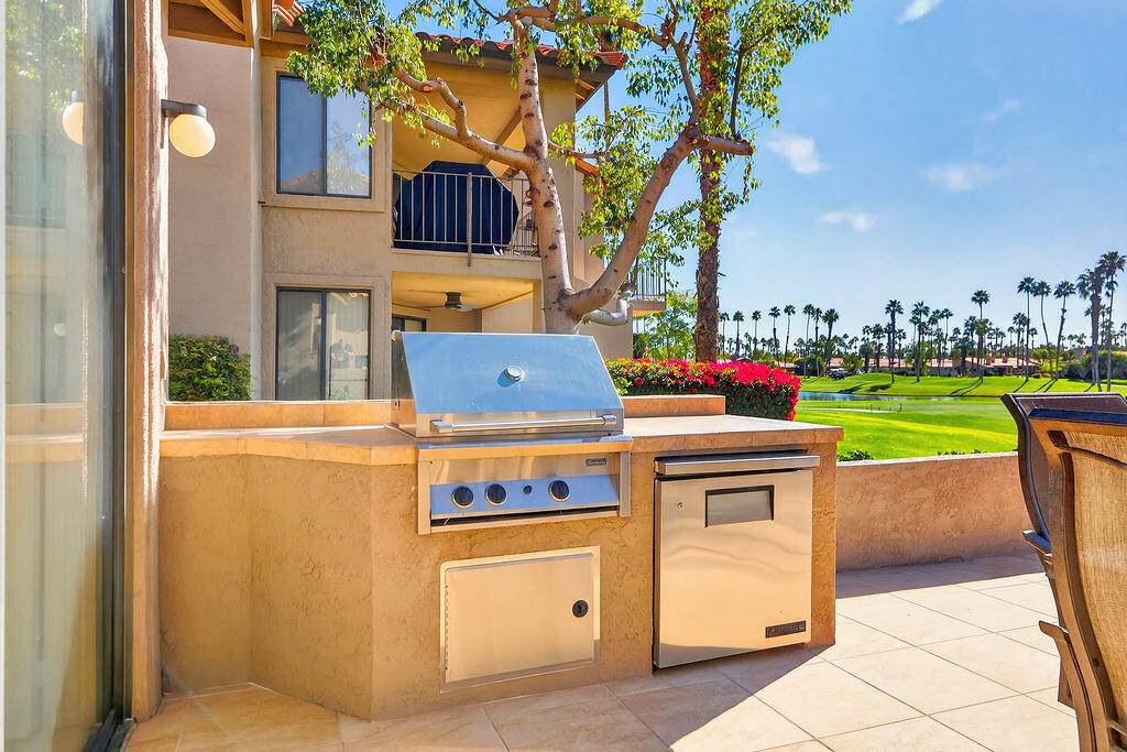 38019 Crocus Lane Palm Desert, CA 92211 - Photo 21 of 28 a open kitchen with a stove and a refrigerator