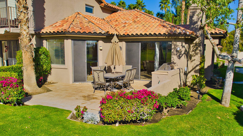 38019 Crocus Lane Palm Desert, CA 92211 - Photo 24 of 28 a front view of a house with a porch and garden