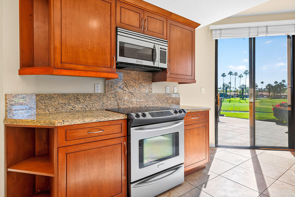 38019 Crocus Lane Palm Desert, CA 92211 - Photo 3 of 28 a kitchen with a stove microwave and cabinets