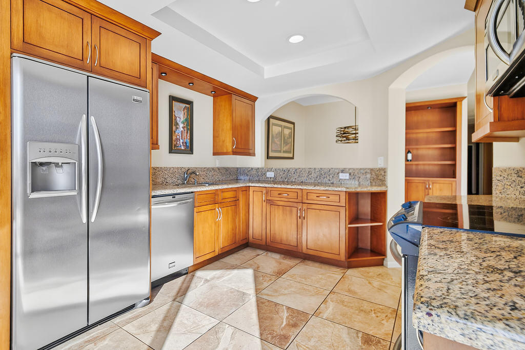 38019 Crocus Lane Palm Desert, CA 92211 - Photo 5 of 28 a kitchen with granite countertop a refrigerator and cabinets