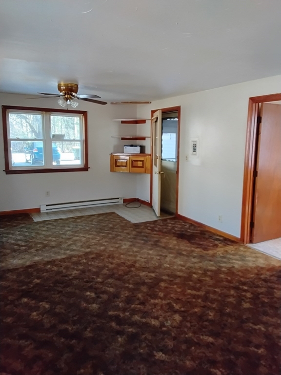 419 Spring Street Hanson, MA 02341 - Photo 12 of 26 a view of a livingroom with wooden floor windows and chandelier