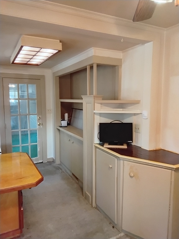 419 Spring Street Hanson, MA 02341 - Photo 14 of 26 a view of a kitchen with furniture and a fireplace