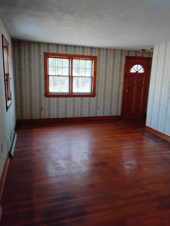 419 Spring Street Hanson, MA 02341 - Photo 20 of 26 an empty room with wooden floor and windows