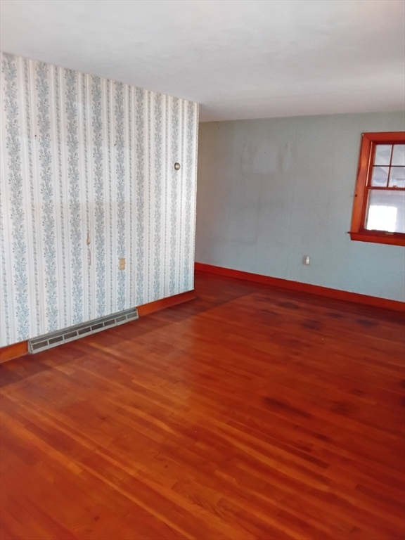 419 Spring Street Hanson, MA 02341 - Photo 24 of 26 a view of a room with wooden floor and white walls
