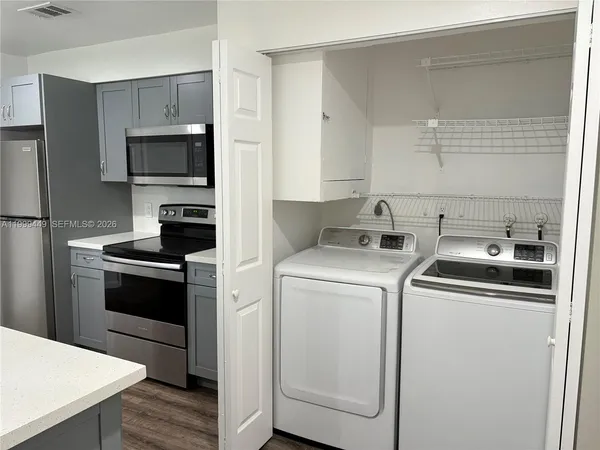 a kitchen with a stove and a refrigerator