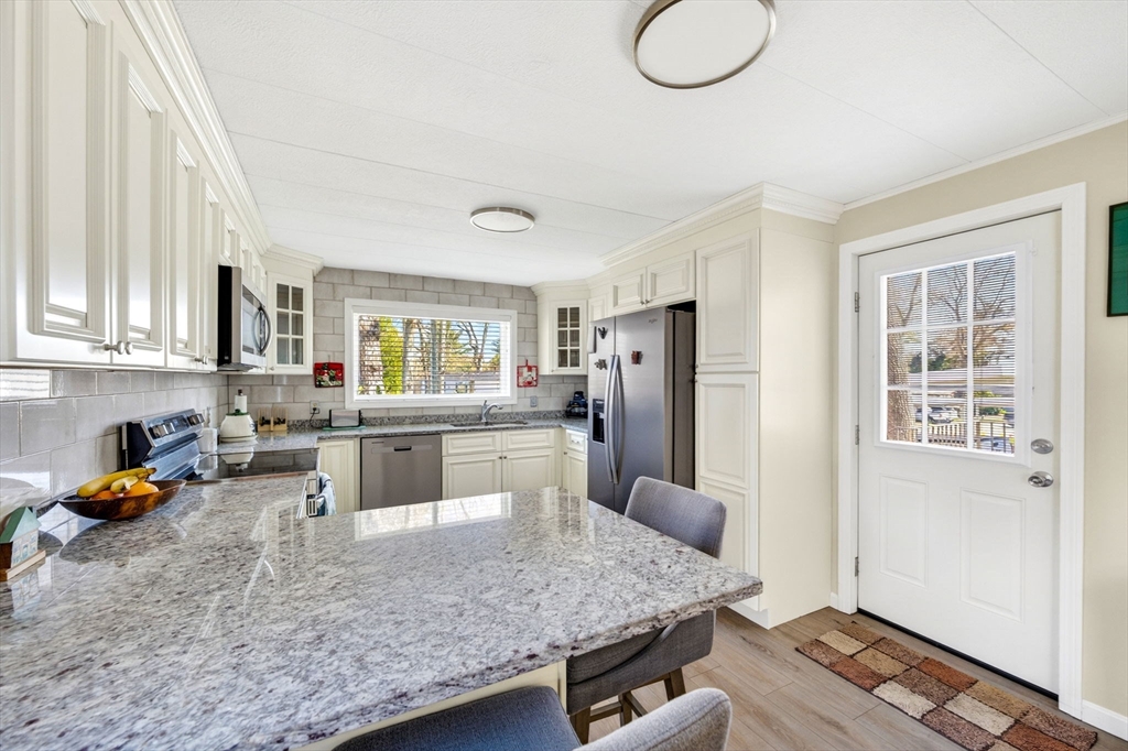 19 Timber Lane Wareham, MA 02571 - Photo 6 of 38 a kitchen with stainless steel appliances granite countertop a sink refrigerator and microwave