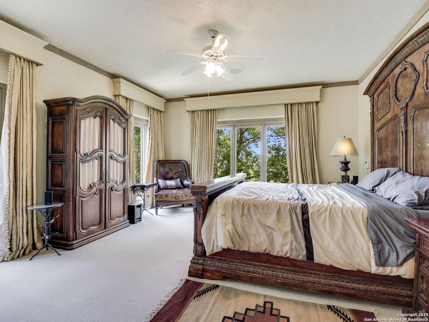 110 Axis Circle Boerne, TX 78006 - Photo 14 of 29 a spacious bedroom with a bed and dresser with mirror