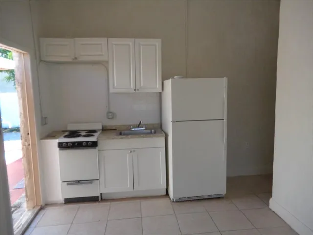 a utility room with cabinets washer and dryer