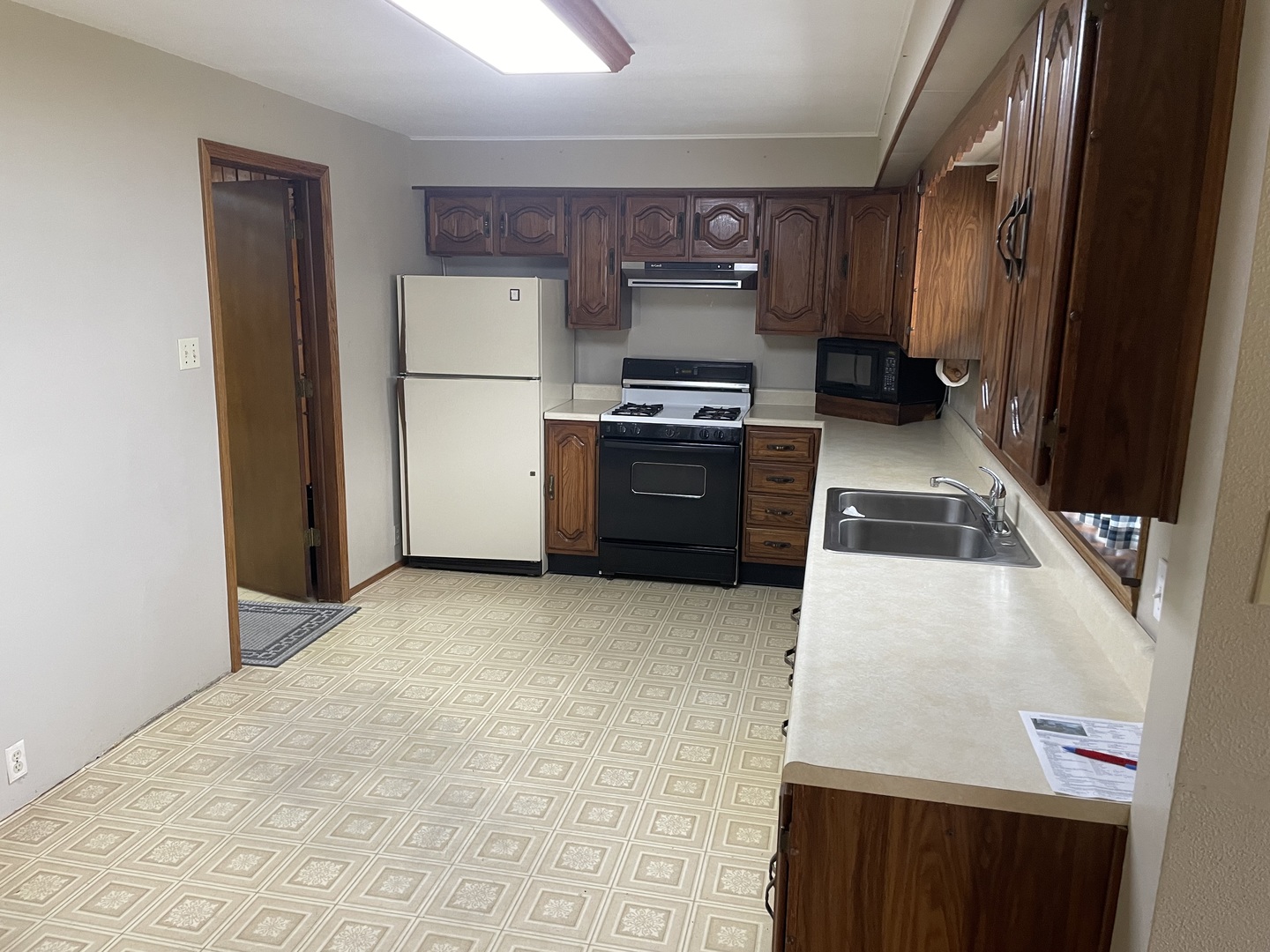 205 North 3rd Street Danforth, IL 60930 - Photo 5 of 17 a kitchen with a refrigerator sink and stove