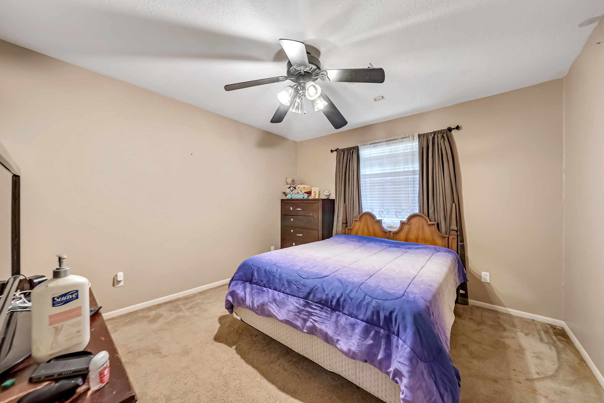 22906 Prairie Bird Lane Spring, TX 77373 - Photo 14 of 14 a bedroom with a bed and a chandelier