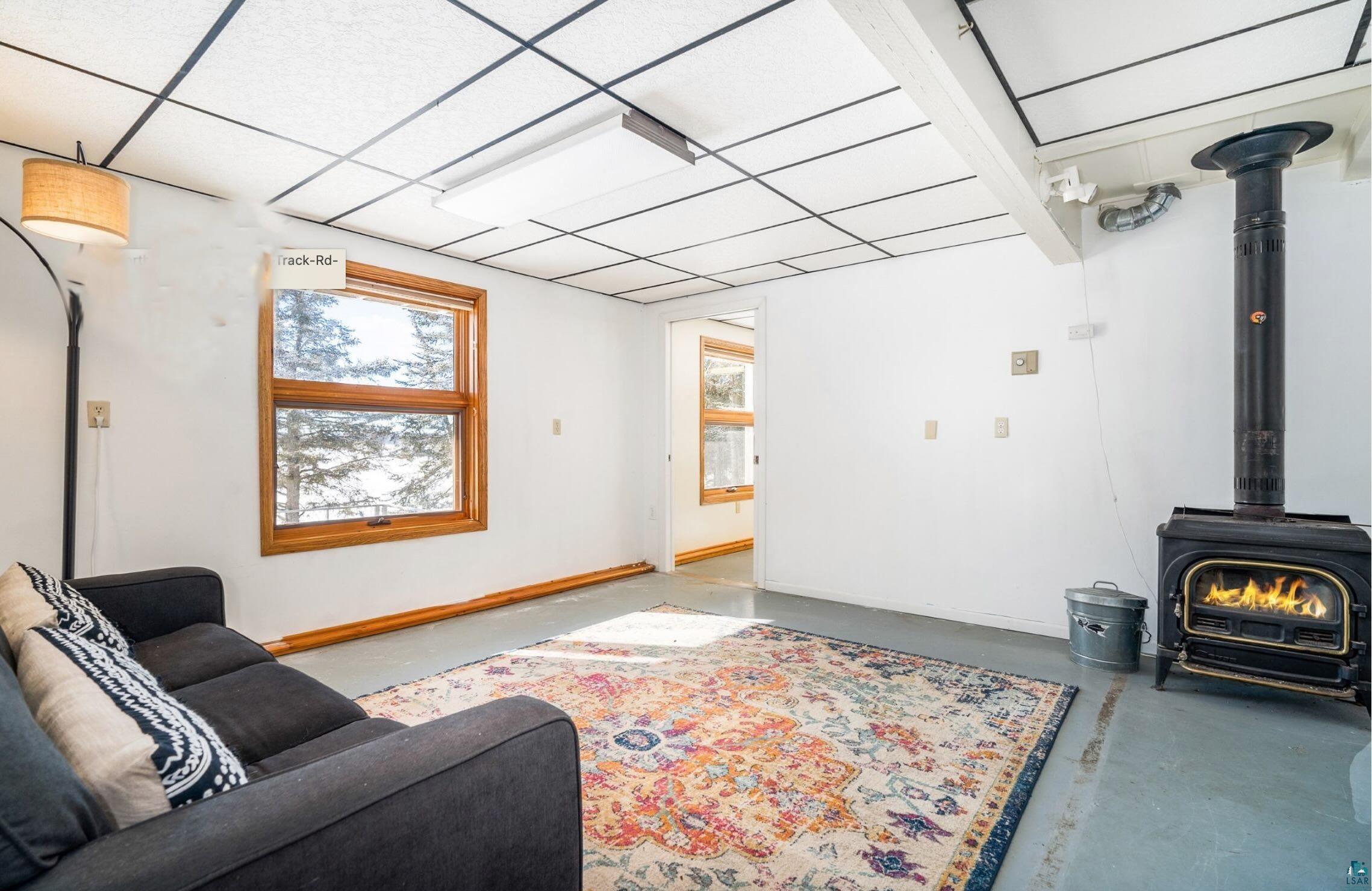 1480 Devil Track Road Grand Marais, MN 55604 - Photo 31 of 38 Living area featuring concrete floors, and wood stove.