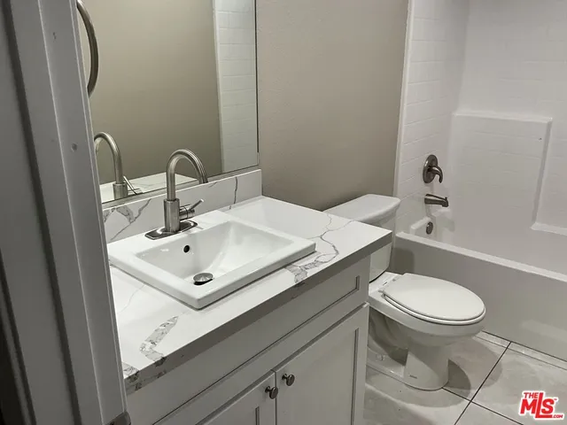 a bathroom with a sink toilet and a mirror