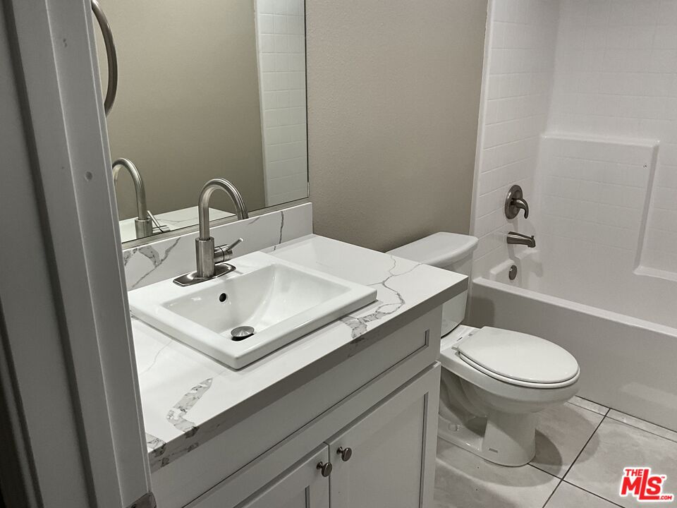 13033 Casco Road Apple Valley, CA 92308 - Photo 11 of 14 a bathroom with a sink toilet and a mirror
