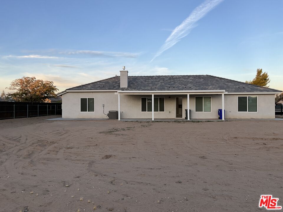 13033 Casco Road Apple Valley, CA 92308 - Photo 14 of 14 a front view of a house with a garden