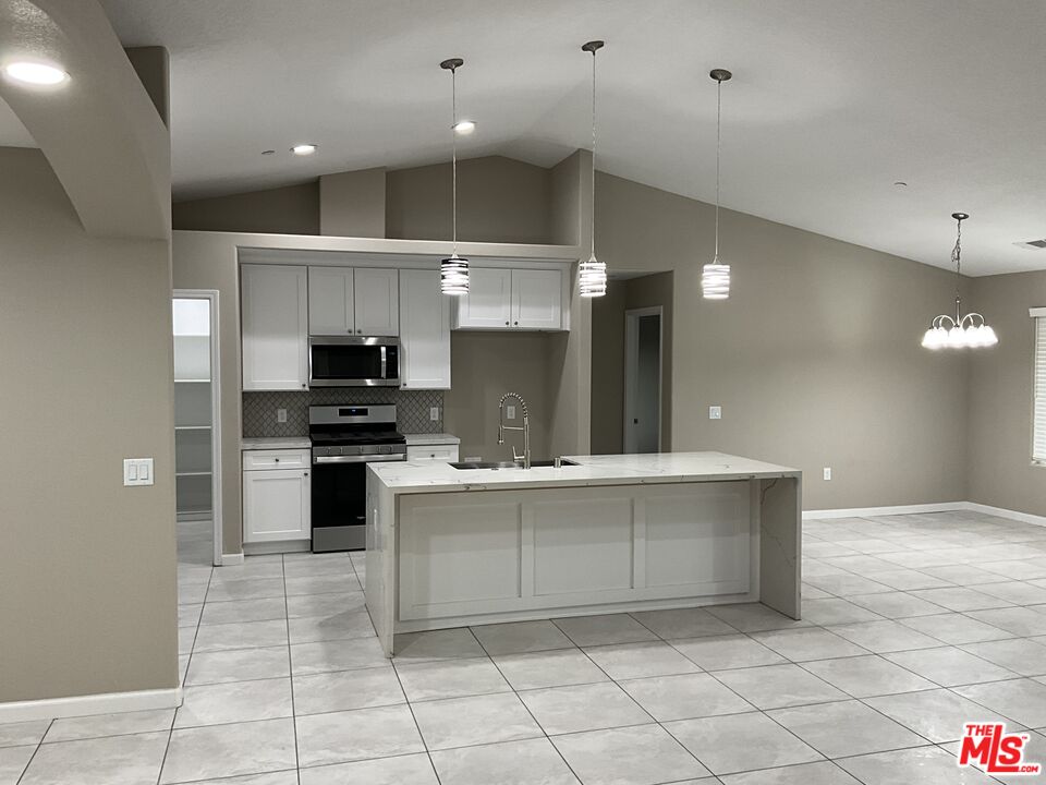 13033 Casco Road Apple Valley, CA 92308 - Photo 4 of 14 a large kitchen with cabinets