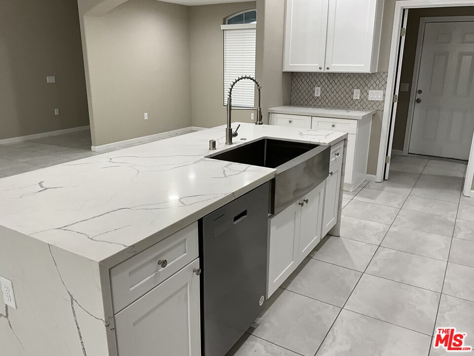 13033 Casco Road Apple Valley, CA 92308 - Photo 6 of 14 a kitchen with a sink cabinets and appliances