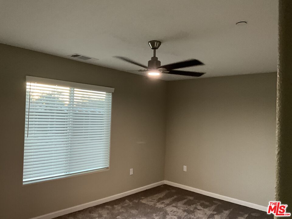 13033 Casco Road Apple Valley, CA 92308 - Photo 10 of 14 an empty room with a window
