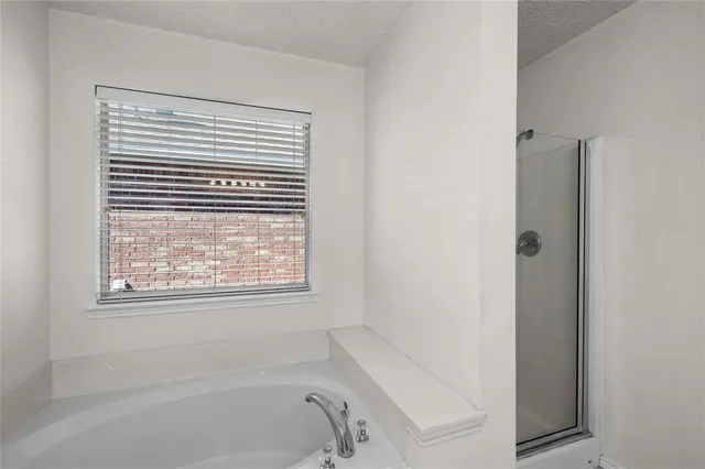 a bathroom with a bathtub and a window