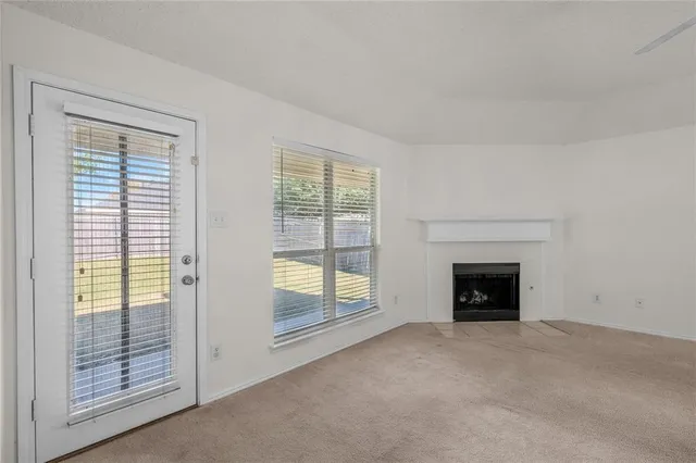 an empty room with furniture and a fireplace
