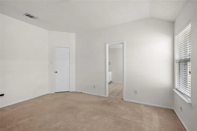 a view of an empty room and a window