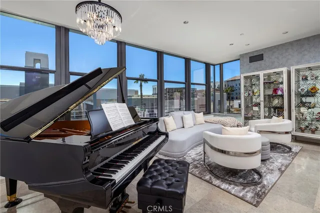 a living room with furniture and a floor to ceiling window