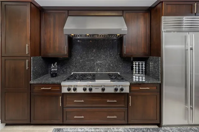 a kitchen with a sink a stove and cabinets