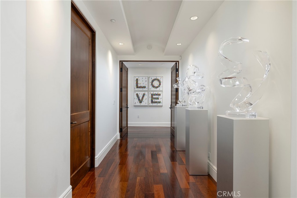 345 East Colorado Boulevard, Unit 404 Pasadena, CA 91101 - Photo 31 of 57 a view of a hallway with wooden floor