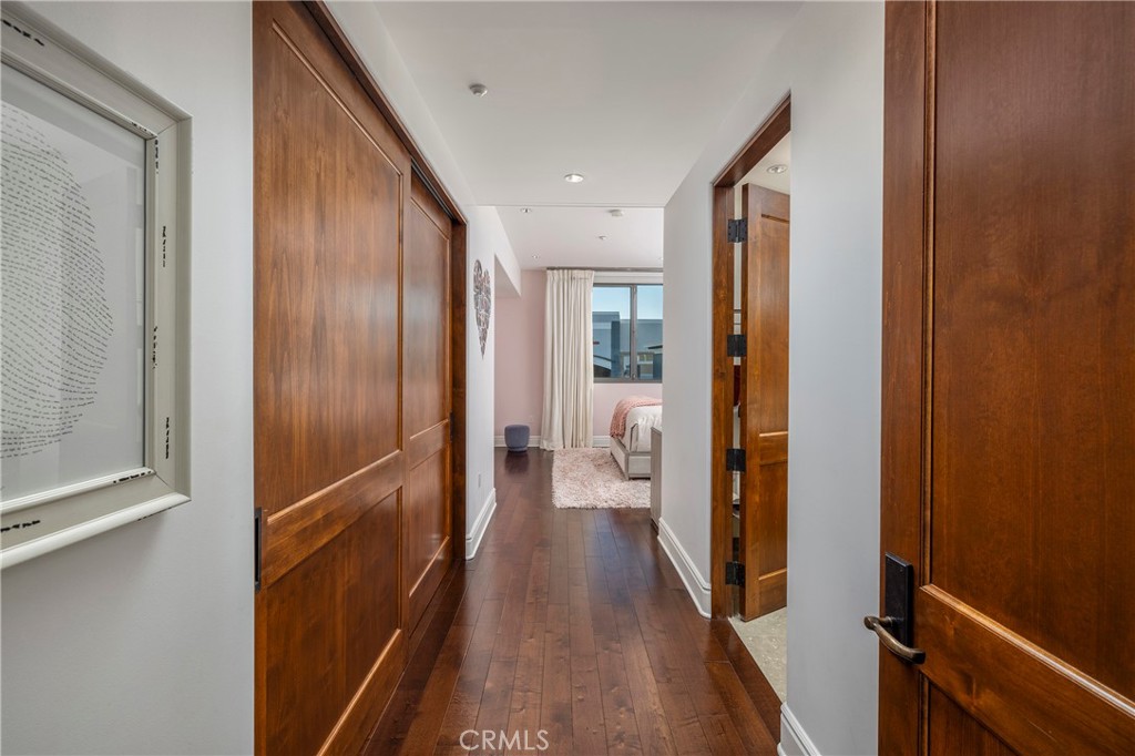 345 East Colorado Boulevard, Unit 404 Pasadena, CA 91101 - Photo 32 of 57 a view of a hallway with wooden floor and a bathroom