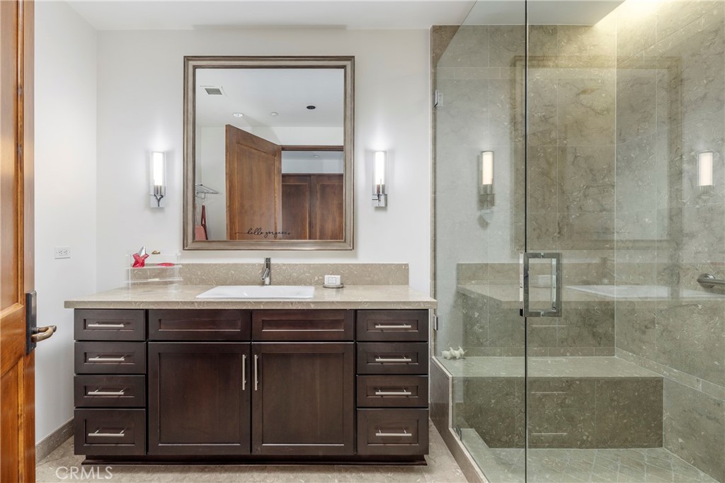 345 East Colorado Boulevard, Unit 404 Pasadena, CA 91101 - Photo 37 of 57 a bathroom with a sink and a mirror