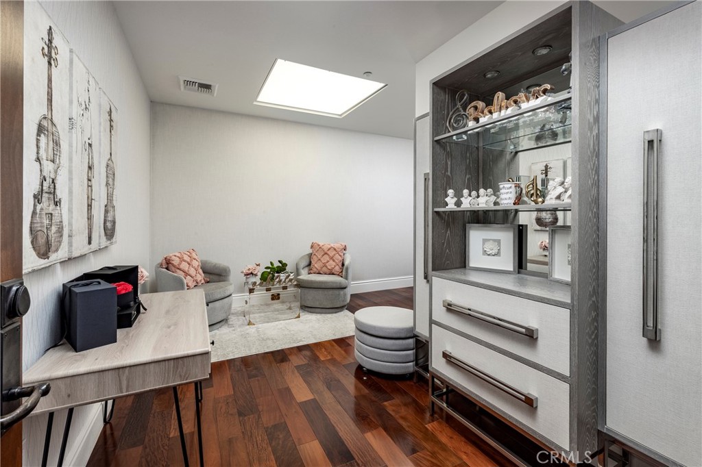 345 East Colorado Boulevard, Unit 404 Pasadena, CA 91101 - Photo 42 of 57 a room with a wooden floor and furniture