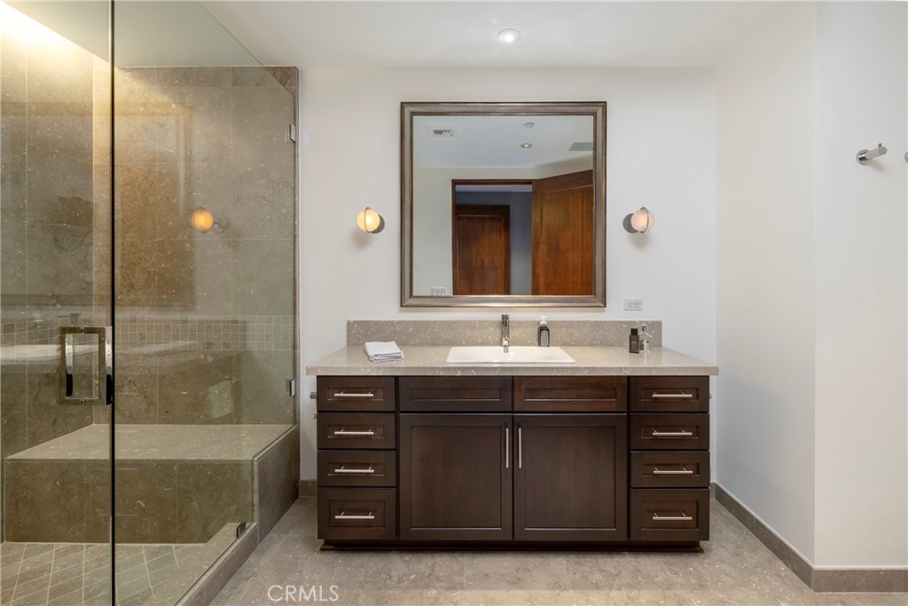 345 East Colorado Boulevard, Unit 404 Pasadena, CA 91101 - Photo 47 of 57 a bathroom with a tub sink and mirror