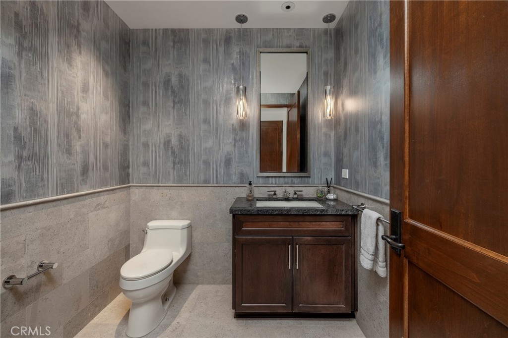 345 East Colorado Boulevard, Unit 404 Pasadena, CA 91101 - Photo 50 of 57 a bathroom with a toilet sink and mirror