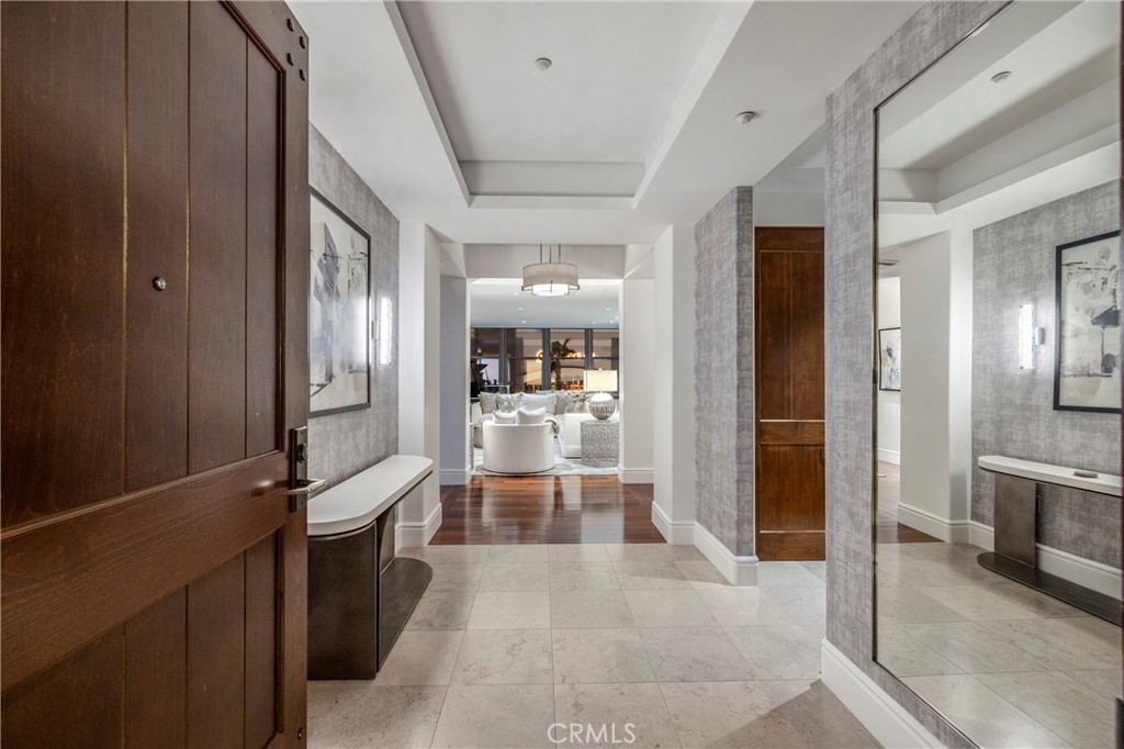 345 East Colorado Boulevard, Unit 404 Pasadena, CA 91101 - Photo 8 of 57 a view of a hallway with wooden floor and a living room