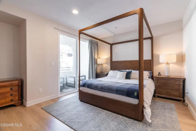 a spacious bedroom with a bed and a cabinets