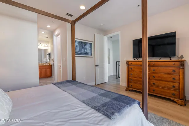 a bedroom with furniture and a flat screen tv