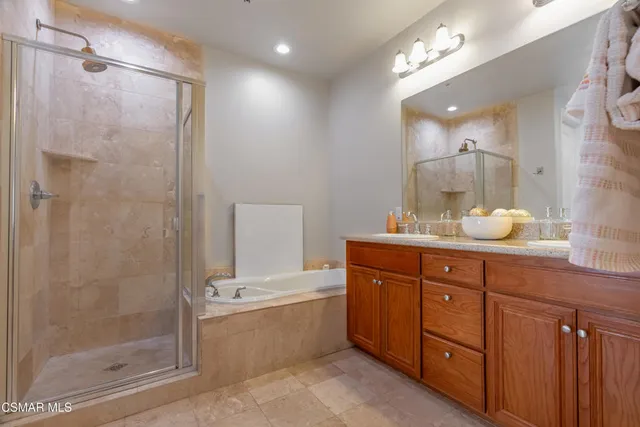 a bathroom with a granite countertop sink mirror and shower