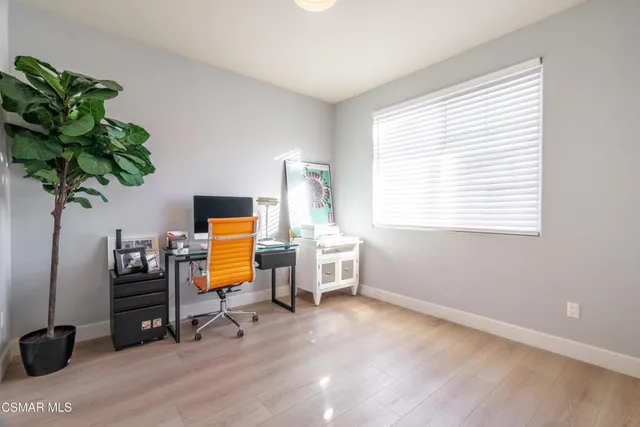 a workspace with furniture hardwood and a window