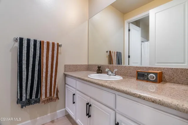 a bathroom with double sink and a mirror