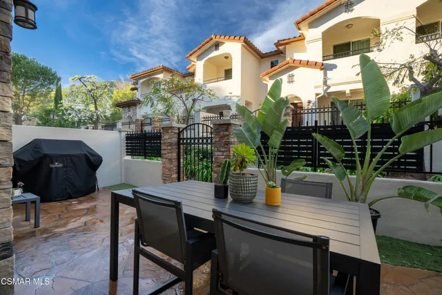 a view of a house with backyard and sitting area